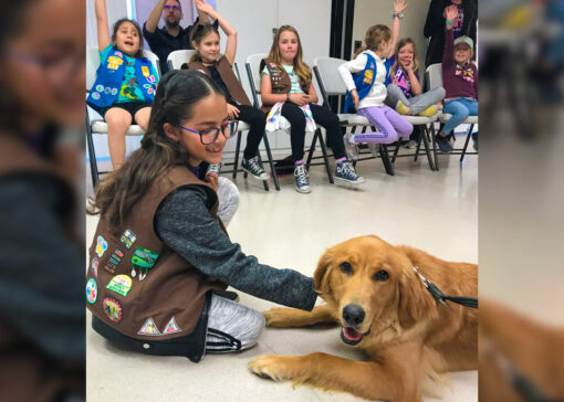 Girl Scout Troop playing with dog